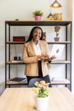 Happy manager working remotely on a laptop in a stylish hotel room, enjoying a productive business