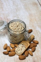 Almonds and ground almonds in glass, Prunus amygdalus