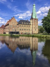 View over moat on moated castle Raesfeld, below reflection on water surface, Hohe Mark nature park