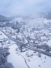 Small snow-covered village in a wooded mountain landscape, shrouded in mist, Enzklösterle, Calw
