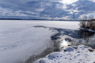 View of Schaalsee, covered with ice and snow, on the bridge tour, a hiking trail around Lake