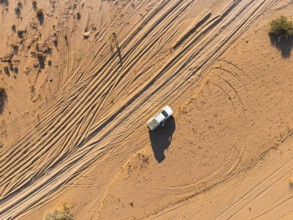 Aerial view, lonely road with offroad car, desert landscape, Erongo, Damaraland, Namibia