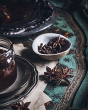 A cozy arrangement featuring a cup of tea infused with anise, presented on an ornate table. The