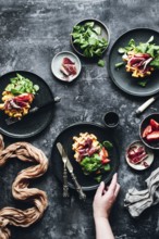 Elegant gourmet dish featuring pumpkin waffles beautifully topped with savory Iberian ham, fresh