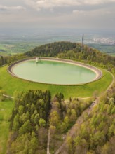 Upper reservoir, view of a water reservoir surrounded by green landscape and forest, Glems