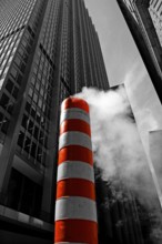 Steaming chimney at a construction site behind a skyscraper, New York City, USA