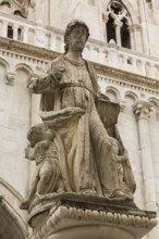Close-up of statue of Saint Lawrence in front of old Gothic Church of Saint Sebastian, St. Lawrence