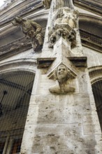 Pillar with sculptures, neo-Gothic architectural detail in the inner courtyard of the town hall in