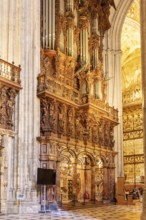 Magnificent organ in the interior of a cathedral with ornate decorations, Seville
