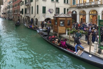 Tourists board gondola for round trip, Venice, Veneto, Italy