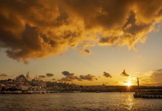A vibrant sunset illuminates the sky above Istanbul, highlighting the silhouettes of mosques and a