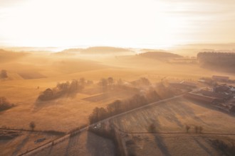 Rural landscape with fields and road in foggy morning light, Gechingen, Calw district, Germany