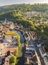 Aerial view of a town along a river with car parks, surrounded by hills and forests, Calw, Black