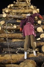 ©Udo Rein, A doll representing the traitor Judas is attached to a pyramid-shaped pile of wood at