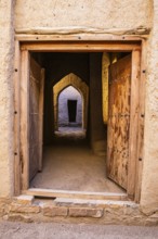 View through an entrance door in the largest preserved mud town in Oman, Al Bilaad, Al Bilaad