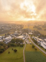 Wide panoramic view of a village at sunrise with green surroundings, Gechingen, Black Forest,