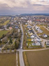 Aerial view of a rural suburb with streets and houses next to open fields, Schopfloch, Freudenstadt