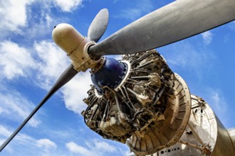 Aeroplane propeller from close up in front of a blue sky with clouds, The propeller of an aeroplane