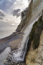 Waterfall of the Kiel stream on the Kiel shore and the famous chalk cliffs on the Baltic Sea coast