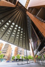 Tall, modern buildings with glass facades and geometric shapes that offer a broad urban