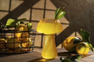 A vibrant lemon drink served in a unique glass with a straw, set against a rustic background. Fresh