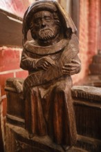 Carved wooden figures on Gothic choir stalls, Nikolaikirche Hanseatic City of Wismar,