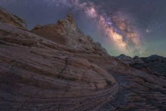 Stunning nightscape of the Milky Way over the unique rock formations in White Pocket, Arizona, USA.
