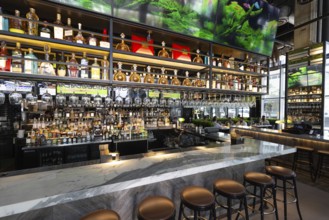Fort Lauderdale restaurant bar with a variety of wine and liquor bottles and glasses on the shelves