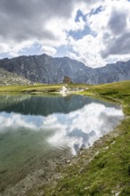 Rocky mountain peaks of the Panargenkamm and mountain hut Neue Reichenberger Hütte, mountain lake