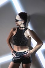 A futuristic cyberpunk fashion model showcases an edgy and dynamic look with metallic accents, bold