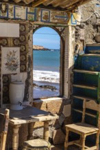 Interior of an old, charming, colorful, abandoned beach house with ocean view in ojos de garza