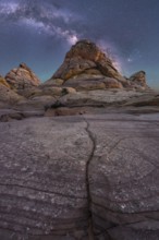 Captivating image of rugged desert rock formations beneath a vibrant Milky Way in Coyote Buttes,