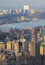 Top view of New York City during sunset, showcasing a panoramic view of buildings bathed in golden