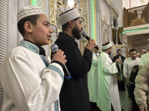 Dozens of Muslims stand in a long queue to view a sacred piece of the Kaaba curtain (Kiswa) while