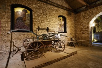 Historic car in a wine cellar surrounded by stone walls, Achaia Clauss Winery, Patras, Peloponnese,