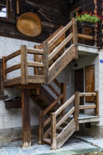 Wooden staircase on the outside of an old house in the historic village centre, Grimentz, Val