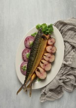 Smoked mackerel, top view, with spices, on a wooden table, no people, selective focus