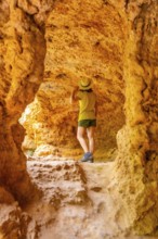 A woman with a hat exploring a cave in the Monasterio de Piedra Natural Park, Aragon