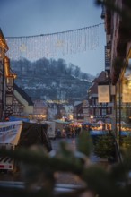 View of an illuminated Christmas market with half-timbered houses in a wintry atmosphere, Christmas