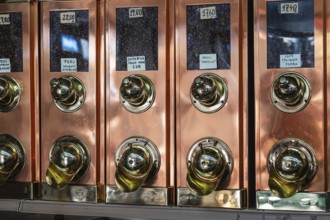 Old-fashioned brass coffee bean collector in a roastery in Barcelona, Spain