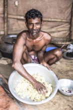 Labourer with rice bowl, Dhaka, Bangladesh
