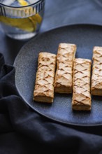 Crisp, golden puff pastry filled with sweet apricot jam, artfully arranged on a sleek black plate.