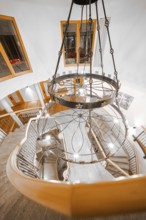 Impressive spiral staircase with decorative chandelier and wooden details, Hotel Krone Lamm,