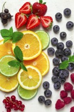 Mix of fruits and berries, set, assortment, sliced citrus fruits, raspberries, blueberries, mint