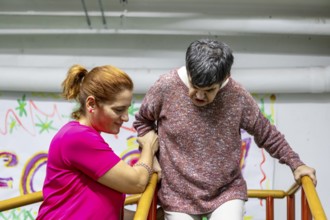 A compassionate caregiver assists a resident in a mental health facility, showcasing empathy and