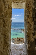 Sea of ??the city of Salvador in Bahia seen through a small window in a sentry box in the historic