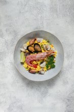 Seafood paella, on a plate, traditional Spanish dish, top view, no people