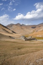 Historic caravanserai Tash Rabat from the 15th century, with yellow hills, Atbashy district in the