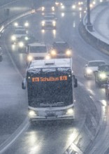 Winter weather, heavy snowfall, traffic jam on the A40 motorway in Essen, school bus, North