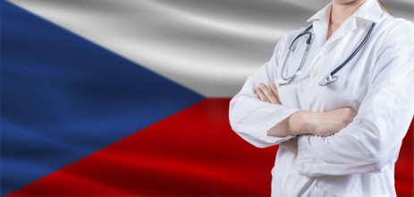 Doctor with crossed arms on Czech Republic flag. Czech Republic health and care concept. Female